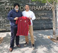This May 18, 2023 handout photo shows Canadian entrepreneur Steve Nijjar (right) alongside Brampton Deputy Mayor Harkirat Singh, holding a Racing Madrid jersey. Nijjar is co-owner of the Spanish side, which he hopes to help rise up from the lower tiers of Spanish soccer. Nijjar used to own the semi-pro Brampton Hitmen soccer team. THE CANADIAN PRESS/HO