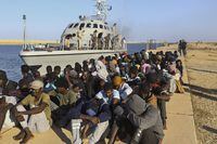 FILE - In this Tuesday, Oct. 1, 2019 file photo, rescued migrants are seated next to a coast guard boat in the city of Khoms, Libya, around 120 kilometers (75 miles) east of Tripoli. Investigators commissioned by the United Nations' top human rights body to examine possible abuses said Monday they have turned up evidence of possible war crimes and crimes against humanity in Libya, in particular against migrants looking to use the restive North African country as way to get to Europe. (AP Photo/Hazem Ahmed,File)