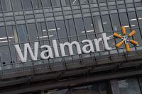 (FILES) In this file photo the Walmart logo is seen on a store in Washington, DC, on March 1, 2019. - Walmart announced on July 15, 2020 that it would require shoppers to wear face masks, joining an increasing number of businesses in mandating the protection amid the latest spike in US coronavirus cases. The world's biggest retailer, which had previously encouraged masks on consumers but not required them, said the mandate would take effect July 20. (Photo by NICHOLAS KAMM / AFP) (Photo by NICHOLAS KAMM/AFP via Getty Images)