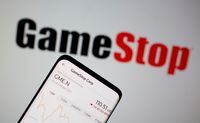 GameStop stock graph is seen in front of the company's logo in this illustration taken February 2, 2021.