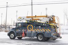 A Hydro Quebec truck is shown in an area without power in Montreal, Saturday, Dec. 24, 2022, following a winter storm in the region.&nbsp;Utility crews in Ontario, Quebec and New Brunswick are still working to restore electricity to thousands of customers who have been in the dark for days after last week's fierce winter storms knocked out their power. THE CANADIAN PRESS/Graham Hughes