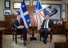 Newfoundland and Labrador Premier Andrew Furey and Quebec Premier François Legault pose in the office of the premier, at the Confederation Building in St. John's, Friday, Feb. 24, 2023. THE CANADIAN PRESS/Paul Daly