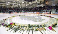 Flowers lie at centre ice as people gather for a vigil at the Elgar Petersen Arena, home of the Humboldt Broncos, to honour the victims of a fatal bus accident in Humboldt, Sask. on Sunday, April 8, 2018. THE CANADIAN PRESS/Jonathan Hayward