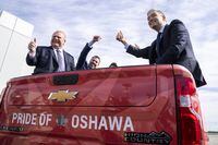 Ontario Premier Doug Ford (left), General Motors Canada outgoing President Scott Bell and Federal Minister of Innovation, Science and Industry François-Philippe Champagne (right) sit in the back of a pickup truck at GM Canada’s Canadian Technical Centre, McLaughlin Advanced Technology Track in Oshawa, Ontario on Monday April 4, 2022. THE CANADIAN PRESS/Frank Gunn