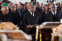 South African President Cyril Ramaphosa (C) looks on during a symbolic mass memorial service in East London on July 6, 2022, after 21 people, mostly teens, died in unclear circumstances at a township tavern last month, in an incident that shocked South Africa. (Photo by Phill Magakoe / AFP) (Photo by PHILL MAGAKOE/AFP via Getty Images)