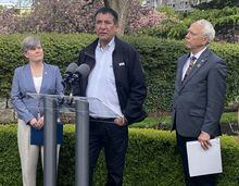 Chief Harley Chingee of B.C.’s McLeod Lake Indian Band talks to media in Victoria, B.C., Wednesday, May 3, 2023, as Indigenous Relations and Reconciliation Minister Murray Rankin and Josie Osborne, energy, mines and low carbon innovation minister, look on. THE CANADIAN PRESS/Dirk Meissner 
