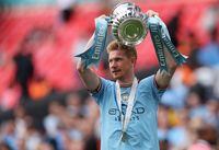 Manchester City's Belgian midfielder Kevin De Bruyne celebrates with the trophy after the English FA Cup final football match between Manchester City and Manchester United at Wembley stadium, in London, on June 3, 2023. (Photo by Adrian DENNIS / AFP) / NOT FOR MARKETING OR ADVERTISING USE / RESTRICTED TO EDITORIAL USE (Photo by ADRIAN DENNIS/AFP via Getty Images)