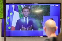 A TV screen in a bar shows French President Emmanuel Macron while he addresses the nation, in Cambrai, France June 22, 2022. REUTERS/Pascal Rossignol