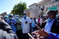 FILE - Health workers led by nurses take part in a demonstration over poor salaries at Parirenyatwa Hospital in Harare on June, 21, 2022. Zimbabwe has decreed a law that bans health workers such as nurses and doctors from prolonged strikes, while imposing punishments of up to 6 months jail time for defiant workers and union leaders. (AP Photo/Tsvangirayi Mukwazhi, File)