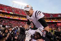 Cincinnati Bengals quarterback Joe Burrow (9) celebrates with teammate Tyler Shelvin at the end of the AFC championship NFL football game against the Kansas City Chiefs, Sunday, Jan. 30, 2022, in Kansas City, Mo. The Bengals won 27-24 in overtime. (AP Photo/Charlie Riedel)