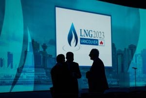 Delegates are silhouetted before the start of the LNG2023 conference, in Vancouver, B.C., Monday, July 10, 2023. THE CANADIAN PRESS/Darryl Dyck