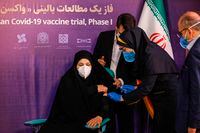 A woman receives an injection during the first trial phase of a locally-made COVID-19 vaccine in Tehran, Iran, on Dec. 29, 2020.
