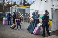 4 migrants (presumably a family, but unconfirmed)  arrive at the unofficial border crossing point at Roxham Road, in Québec on the 24/03/2023. They were advised by Police officers before corssing that they will be arrested.  A female officer picks up a ball that one of the childrenn dropped and returns it to the child. 
