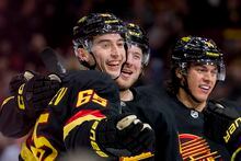 Jan 27, 2023; Vancouver, British Columbia, CAN; Vancouver Canucks forward Ilya Mikheyev (65) celebrates after scoring a goal against the Columbus Blue Jackets with defenseman Ethan Bear (74) and forward Brock Boeser (6) in the first period at Rogers Arena. Mandatory Credit: Bob Frid-USA TODAY Sports