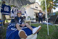 Lifelong Leafs fan Stacey Saul (back right), originally from Mississauga and now living in Clearwater, Fla., has banished her 17-year-old son, Logan, a Tampa Bay Lightning fan, to a tent in the family’s front yard during this Stanley Cup playoff series. MARK TAYLOR FOR THE GLOBE AND MAIL