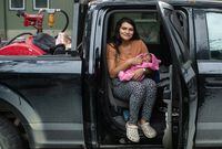 Tanisha Edison and her partner had to welcome the newest addition to their family more than 1,000 kilometres away from home. Edison sits with her newborn baby, Nova Grace Bruneau, in Edmonton on Sunday, Sept. 3, 2023. THE CANADIAN PRESS/Jason Franson
