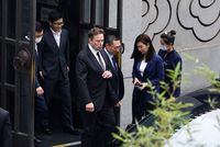 Tesla Chief Executive Officer Elon Musk walks next to Tesla Senior Vice President Tom Zhu and Vice President Grace Tao as he leaves a restaurant in Beijing, China May 31, 2023. REUTERS/Tingshu Wang