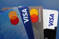 FILE - Credit cards as seen July 1, 2021, in Orlando, Fla. Many Americans say their household expenses are outpacing earnings in 2023 according to a new poll from AP-NORC Center for Public Affairs Research. (AP Photo/John Raoux, File)