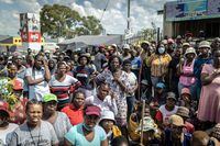 Residents listen to community leaders speaking during a protest against the rise of crime in the area in Diepsloot, South Africa, on April 6, 2022. (Photo by GUILLEM SARTORIO / AFP) (Photo by GUILLEM SARTORIO/AFP via Getty Images)