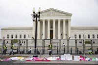 Signs lay in front of fencing during a rally for for abortion rights in front of the Supreme Court of the United States in Washington, Saturday, May 14, 2022, during protests across the country. (AP Photo/Amanda Andrade-Rhoades)