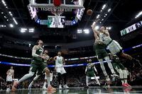 Boston Celtics' Jayson Tatum shoots past Milwaukee Bucks' Grayson Allen during the second half of Game 6 of an NBA basketball Eastern Conference semifinals playoff series Friday, May 13, 2022, in Milwaukee. The Celtics won 108-95 to tie the series at 3-3. (AP Photo/Morry Gash)