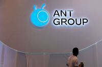FILE PHOTO: A man walks past an Ant Group logo at the World Artificial Intelligence Conference (WAIC) in Shanghai, China, July 8, 2021. REUTERS/Yilei Sun