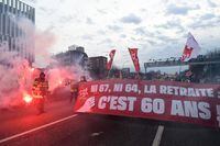CGT unionists march with flares and banners on the ring road as they block the traffic to protest, a day after the French government pushed a pensions reform through parliament without a vote, using the article 49,3 of the constitution, in Paris on March 17, 2023. - French President faces intensified protests and accusations of anti-democratic behaviour after pushing through a contentious pension reform without a parliamentary vote. (Photo by BERTRAND GUAY / AFP) (Photo by BERTRAND GUAY/AFP via Getty Images)
