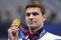 FILE - Evgeny Rylov of the Russian Olympic Committee poses with his gold medal for the men's 100-meter backstroke final at the 2020 Summer Olympics, Tuesday, July 27, 2021, in Tokyo, Japan. A statement from swimming's world governing body, FINA, on Thursday, April 21, 2022, announced that Rylov has been banned from the sport for nine months for appearing at a rally in support of President Vladimir Putin and Russia's invasion of Ukraine. (AP Photo/Matthias Schrader, File)