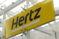FILE PHOTO: Signage is seen at Hertz rental car at John F. Kennedy International Airport in Queens, New York City, U.S., March 30, 2022. REUTERS/Andrew Kelly/File Photo