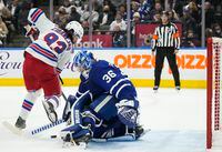 Toronto Maple Leafs goaltender Jack Campbell (36) makes a save against New York Rangers forward Mika Zibanejad (93) during first period NHL hockey action in Toronto on Thursday, November 18, 2021.
