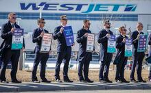 WestJet pilots are poised to get a 24 per cent pay bump over four years under an agreement-in-principle between the company and the union. Members of the Air Line Pilots Association demonstrate amid contract negotiations outside the WestJet headquarters in Calgary, Alta., Friday, March 31, 2023.THE CANADIAN PRESS/Jeff McIntosh