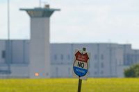 A sign stands in front of a federal prison complex in Terre Haute, Ind., on Aug. 26, 2020.