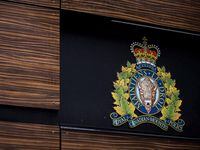 The RCMP logo is seen outside Royal Canadian Mounted Police "E" Division Headquarters, in Surrey, B.C., Friday, April 13, 2018. An investigation prompted by Canada's War Crimes Program into a video threatening people in the Democratic Republic of Congo has resulted in charges against a man living in B.C. THE CANADIAN PRESS/Darryl Dyck