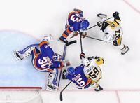 UNIONDALE, NEW YORK - MAY 22: Ilya Sorokin #30 of the New York Islanders defends the net against the Pittsburgh Penguins  in Game Four of the First Round of the 2021 Stanley Cup Playoffs at the Nassau Coliseum on May 22, 2021 in Uniondale, New York. The Islanders defeated the Penguins 4-1. (Photo by Bruce Bennett/Getty Images)
