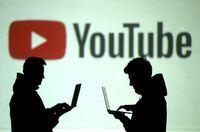 FILE PHOTO: Silhouettes of mobile device users are seen next to a screen projection of Youtube logo in this picture illustration taken March 28, 2018.  REUTERS/Dado Ruvic/Illustration/File Photo/File Photo