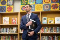 Ontario Education Minister Stephen Lecce stands in the library at Ogden Junior Public School, in Toronto, on Nov. 27, 2019.