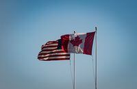 Canadian and U.S. flags fly above the Peace Arch monument at the Douglas-Peace Arch Canada-U.S. border crossing in Surrey, B.C., on Thursday, May 13, 2021. Darryl Dyck/The Globe and Mail