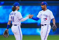 TORONTO, ONTARIO - SEPTEMBER 18: Marcus Semien #10 and Bo Bichette #11 of the Toronto Blue Jays celebrate defeating the Minnesota Twins in their MLB game at the Rogers Centre on September 18, 2021 in Toronto, Ontario, Canada. (Photo by Mark Blinch/Getty Images)