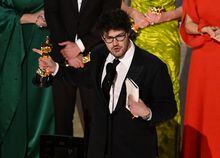 Canadian filmmaker Daniel Roher (C) accepts the Oscar for Best documentary feature film for "Navalni" onstage during the 95th Annual Academy Awards at the Dolby Theatre in Hollywood, California on March 12, 2023. (Photo by Patrick T. Fallon / AFP) (Photo by PATRICK T. FALLON/AFP via Getty Images)