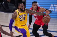 Los Angeles Lakers' LeBron James (23) reaches for the ball as Houston Rockets' Russell Westbrook (0) defends during the second half of an NBA conference semifinal playoff basketball game Thursday, Sept. 10, 2020, in Lake Buena Vista, Fla. (AP Photo/Mark J. Terrill)