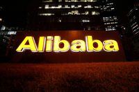 FILE PHOTO: The logo of Alibaba Group is lit up at its office building in Beijing, China August 9, 2021. REUTERS/Tingshu Wang/File Photo