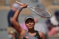 Naomi Osaka celebrates after defeating Patricia Maria Tig during their first round French Open match, in Paris, on May 30, 2021.