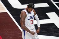 Los Angeles Clippers guard Paul George (13) flexes his muscles after scoring against the Utah Jazz during the first half of Game 5 of a second-round NBA basketball playoff series Wednesday, June 16, 2021, in Salt Lake City. (AP Photo/Rick Bowmer)