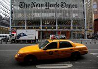 FILE PHOTO: A taxi passes by in front of The New York Times head office in New York, February 7, 2013.  REUTERS/Carlo Allegri/File Photo