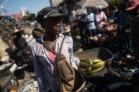 A woman carries plantains for sale at the Petion-Ville street market in Port-au-Prince, Haiti, October 18, 2022. REUTERS/Ricardo Arduengo