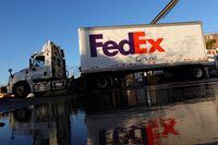 FILE PHOTO: A FedEx delivery truck exits a facility in Brooklyn, New York City, U.S., May 9, 2022. REUTERS/Andrew Kelly/File Photo