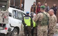 Lebanese army members and the United Nations peacekeepers (UNIFIL) stand near of what witnesses stated to be the UNIFIL vehicle that was carrying the Irish soldier who was killed on a U.N. peacekeeping Patrol, in Al-Aqbieh, south Lebanon December 15, 2022. REUTERS/Aziz Taher