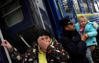 A woman and a little girl react as she cannot immediately board a train departing to Poland following Russia’s invasion of Ukraine at the main train station in Lviv, Ukraine, March 4, 2022.   REUTERS/Kai Pfaffenbach
