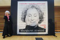 Renowned Canadian writer Margaret Atwood poses for a photograph next to her Canada Post special stamp in her honour in Toronto on Thursday, November 25, 2021. THE CANADIAN PRESS/Nathan Denette