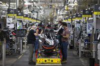 Workers are seen on the assembly line making snowmobiles at BRP Inc., in Valcourt, Quebec, October 8, 2020.   (Christinne Muschi /The Globe and Mail)